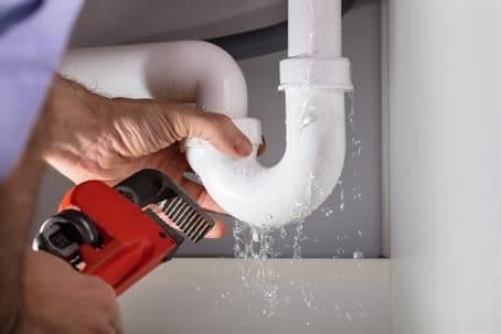Plumber Fixing Sink Pipe