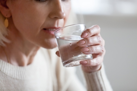 woman drinking a glass of water